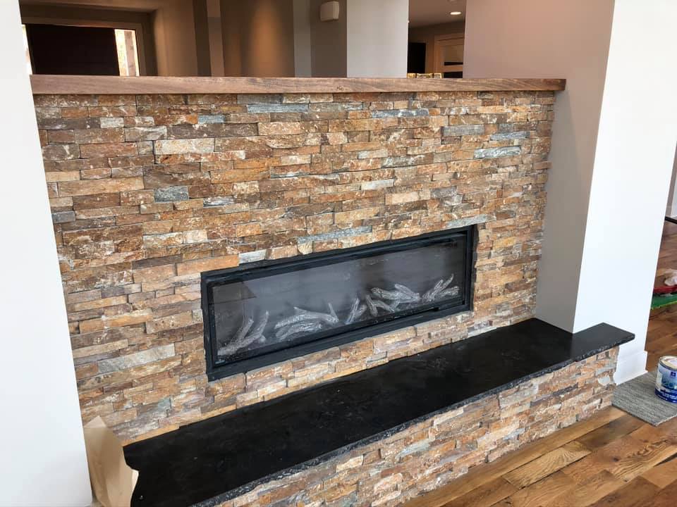 Stone fireplace with granite hearth in local KC metro residence. 